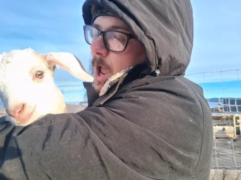 John holding Oreck the goat kid